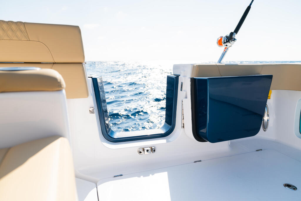 Twin side-entry cabin doors with open views of calm blue ocean water from boat deck