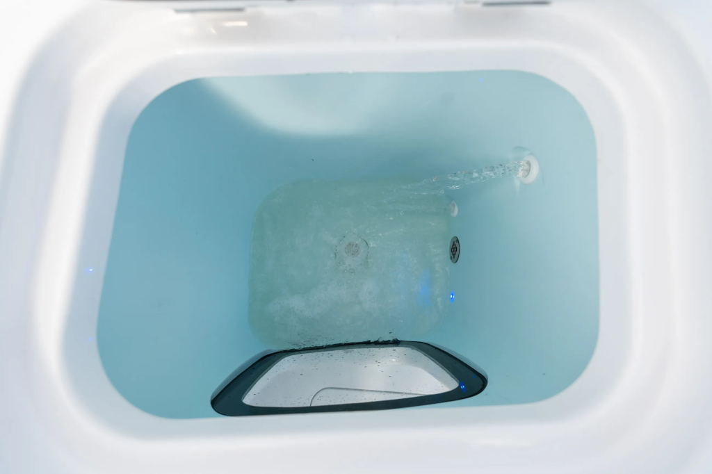 Live well tank with turquoise water and integrated aeration system inside boat