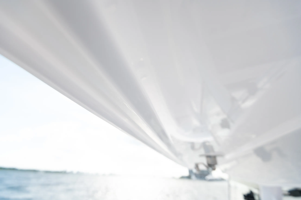 View from beneath the hard-top canopy of a boat running offshore on open water