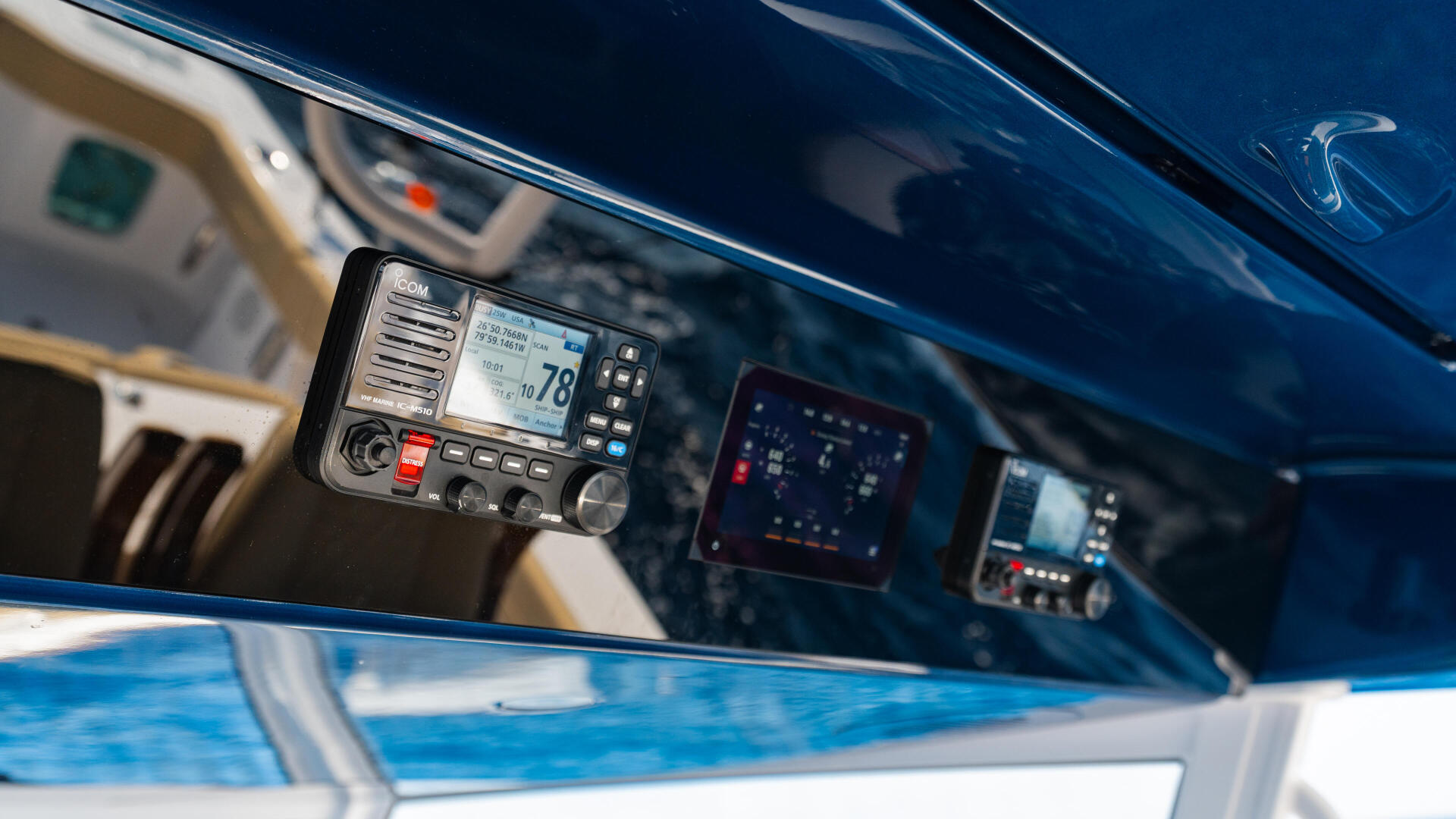 Marine VHF radio mounted in boat helm with navigation and communication electronics visible